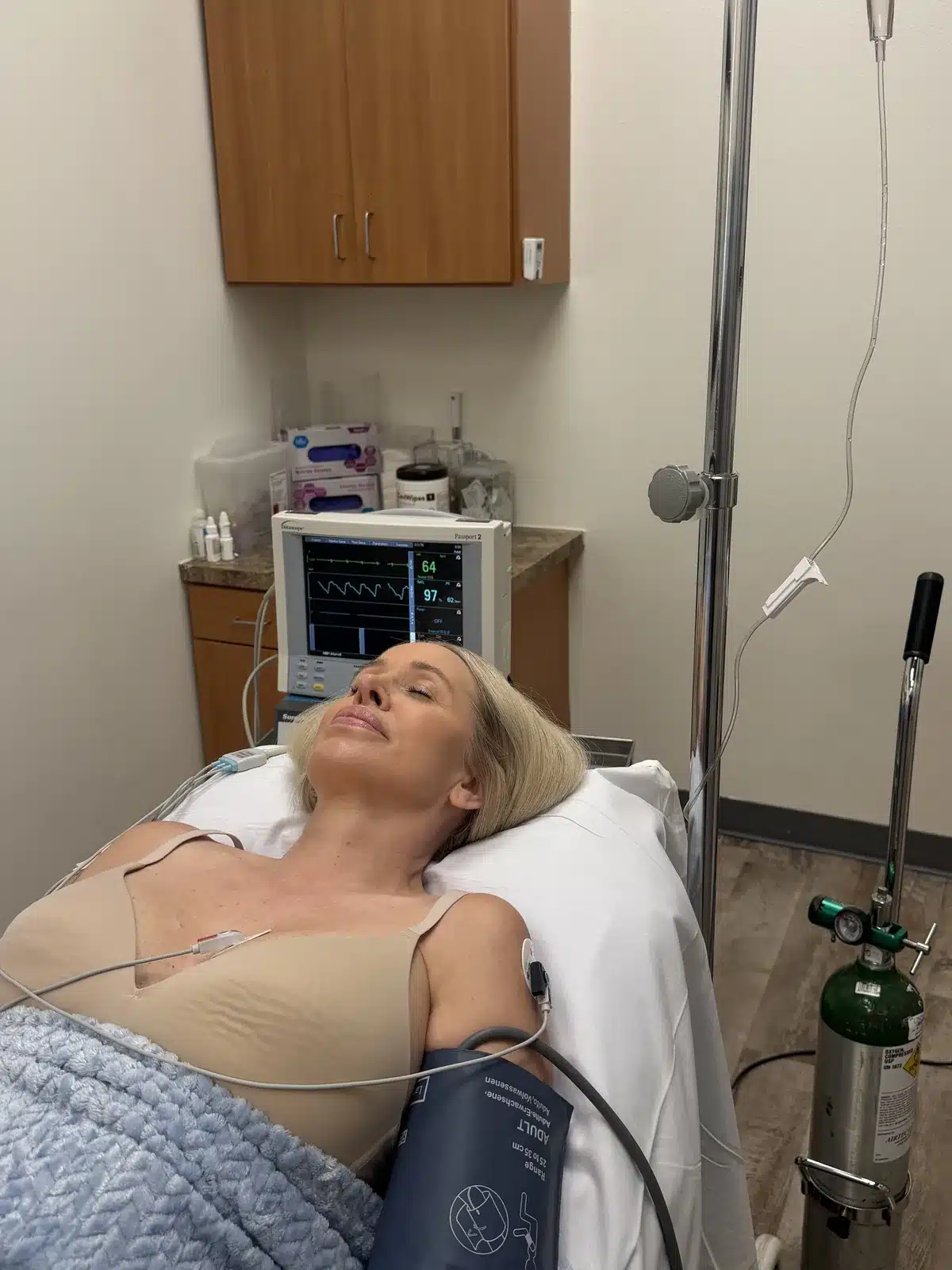 Relaxed patient under awake conscious sedation with supplemental oxygen and blood-pressure monitoring at Dr. Troell's Las Vegas clinic