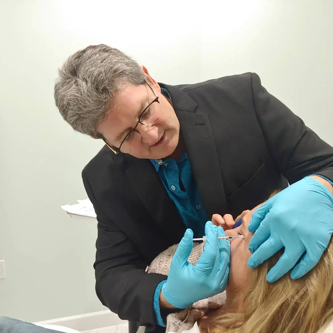 Dr. Troell injecting facial filler with a blunt-tip technique