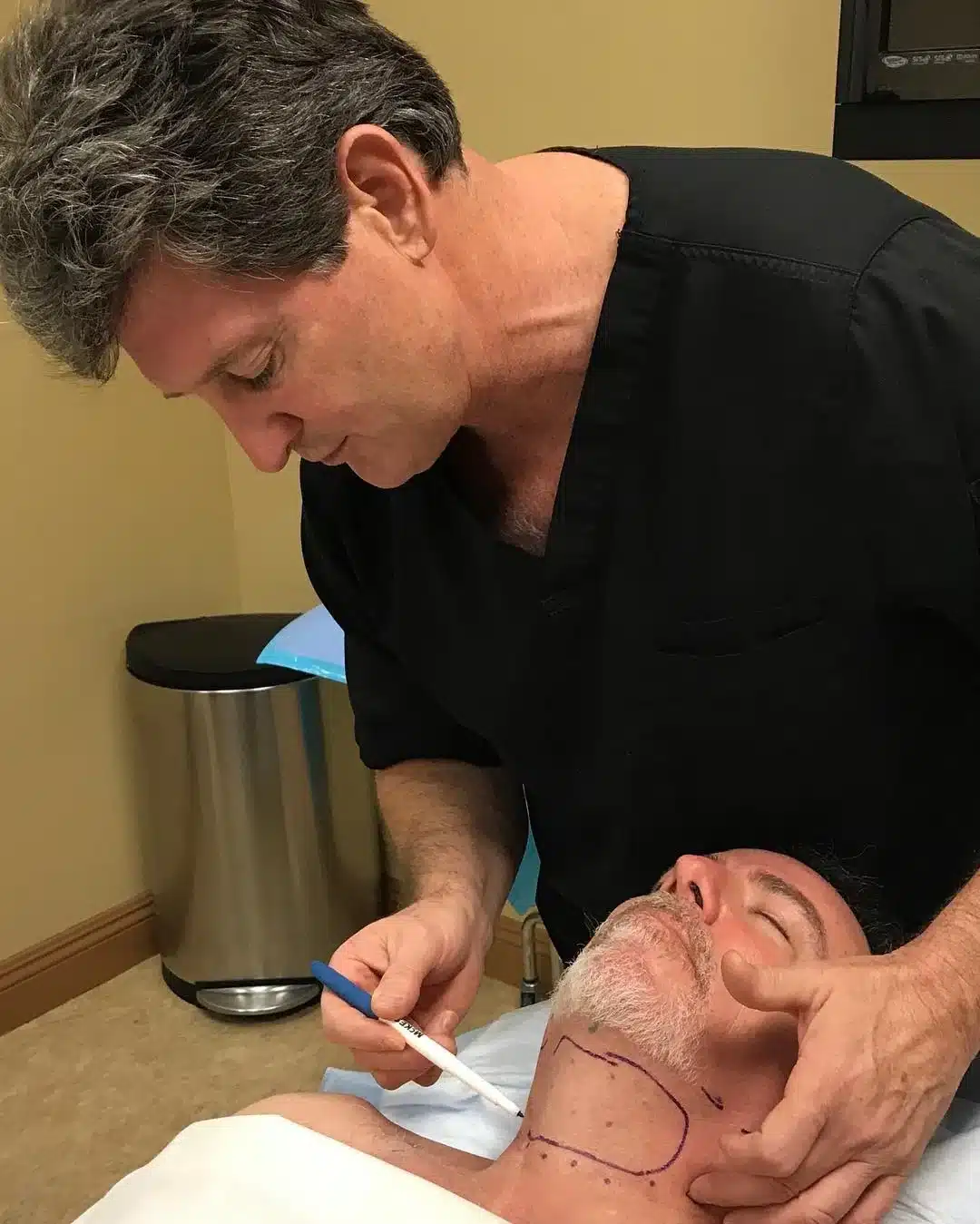 Dr. Robert Troell marking anatomic landmarks on a patient before facelift surgery